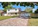 Charming two-story home with a brick driveway, manicured lawn, and stone accents on the facade at 8798 94Th St, Seminole, FL 33777