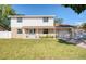 Inviting two-story home with a manicured lawn, stone accents, and a quaint front porch at 8798 94Th St, Seminole, FL 33777