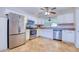 Bright kitchen featuring stainless steel appliances, white cabinets, and tile floors at 8798 94Th St, Seminole, FL 33777