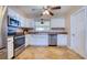 A traditionally styled kitchen offers tiled floors, white cabinetry, and stainless appliances for a functional cooking space at 8798 94Th St, Seminole, FL 33777