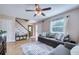 Inviting living room with tile floors, comfortable seating, and a staircase at 8798 94Th St, Seminole, FL 33777