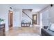 Open-concept living area with tile floors, a staircase, and a cozy seating arrangement at 8798 94Th St, Seminole, FL 33777