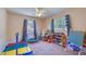 Bright playroom with hardwood floors, featuring colorful toys, a mini-trampoline, and ample natural light at 8798 94Th St, Seminole, FL 33777