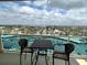 Balcony featuring a patio table with view of a parking lot and the city at 880 Mandalay Ave # C704, Clearwater Beach, FL 33767
