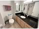 Bathroom featuring dark granite countertops, a vanity, and ample lighting at 880 Mandalay Ave # C704, Clearwater Beach, FL 33767