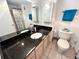 Well-lit bathroom featuring a granite-topped vanity with ample storage and modern fixtures at 880 Mandalay Ave # C704, Clearwater Beach, FL 33767