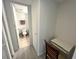 Hallway leading to the clean bathroom with a tiled floor and white toilet at 880 Mandalay Ave # C704, Clearwater Beach, FL 33767