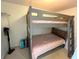 Cozy bedroom with a sturdy bunk bed and playful pink bedding at 880 Mandalay Ave # C704, Clearwater Beach, FL 33767