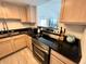 Updated kitchen with stainless steel appliances and black countertops at 880 Mandalay Ave # C704, Clearwater Beach, FL 33767