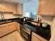 Updated kitchen with stainless steel appliances and black countertops at 880 Mandalay Ave # C704, Clearwater Beach, FL 33767