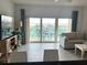 Bright living room with a balcony offering stunning views and a comfortable seating area at 880 Mandalay Ave # C704, Clearwater Beach, FL 33767