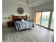 Bright bedroom with balcony access, a ceiling fan, and modern flooring at 880 Mandalay Ave # C704, Clearwater Beach, FL 33767