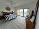 Bright bedroom with a ceiling fan and balcony access, and views at 880 Mandalay Ave # C704, Clearwater Beach, FL 33767
