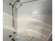 A shower stall lined with white tiles and equipped with a modern shower head at 880 Mandalay Ave # C704, Clearwater Beach, FL 33767