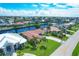 Aerial view showcases waterfront homes nestled along a scenic canal, under a sunny blue sky at 890 Coronado Dr, Punta Gorda, FL 33950