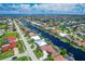 Extensive network of canal homes creating a beautiful waterfront community under a blue sky with scattered clouds at 890 Coronado Dr, Punta Gorda, FL 33950