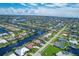 Extensive network of canal homes creating a beautiful waterfront community under a blue sky with scattered clouds at 890 Coronado Dr, Punta Gorda, FL 33950