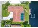 Stunning aerial view of waterfront home, featuring a screened pool, private dock, and beautifully landscaped yard at 890 Coronado Dr, Punta Gorda, FL 33950