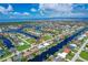 Stunning aerial view of waterfront community with canals, beautiful homes and manicured lawns leading out to a bay at 890 Coronado Dr, Punta Gorda, FL 33950