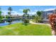 Lush green backyard with access to the canal and a boat dock, perfect for waterfront living at 890 Coronado Dr, Punta Gorda, FL 33950