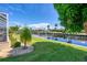 Lush green backyard with access to the canal and a boat dock, perfect for waterfront living at 890 Coronado Dr, Punta Gorda, FL 33950