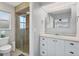 Bright bathroom featuring a glass-enclosed shower and white vanity with ample storage at 890 Coronado Dr, Punta Gorda, FL 33950