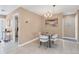 Cozy dining area features a modern chandelier, round table, and comfortable seating at 890 Coronado Dr, Punta Gorda, FL 33950