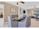 Elegant dining room with glass table, gray upholstered chairs, and built-in shelving at 890 Coronado Dr, Punta Gorda, FL 33950