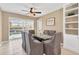 Bright dining area with glass table, six chairs, and a sliding door leading to a pool at 890 Coronado Dr, Punta Gorda, FL 33950