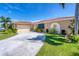 Charming home with a well-manicured lawn, circular driveway, and beautiful landscaping at 890 Coronado Dr, Punta Gorda, FL 33950
