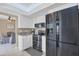 Well-lit kitchen with stainless steel appliances, white cabinetry, granite countertops and an adjacent dining area at 890 Coronado Dr, Punta Gorda, FL 33950
