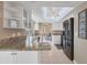 Modern kitchen with white cabinets, granite countertops, stainless appliances, tile floor, and natural lighting at 890 Coronado Dr, Punta Gorda, FL 33950