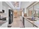 Bright and modern kitchen featuring white cabinets, granite countertops, stainless appliances and open dining area at 890 Coronado Dr, Punta Gorda, FL 33950