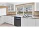 Bright kitchen features white cabinets, granite countertops, stainless steel appliances and a view of the pool at 890 Coronado Dr, Punta Gorda, FL 33950