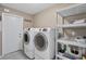 Well-organized laundry room with modern appliances and shelving for storage at 890 Coronado Dr, Punta Gorda, FL 33950
