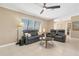 Inviting living room featuring comfortable seating, a ceiling fan, and natural light at 890 Coronado Dr, Punta Gorda, FL 33950
