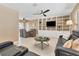 Spacious living room with comfortable seating, a large built-in entertainment center, and an adjacent dining area at 890 Coronado Dr, Punta Gorda, FL 33950