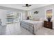 Spacious main bedroom with a ceiling fan, a sliding door to the pool area, and two nightstands at 890 Coronado Dr, Punta Gorda, FL 33950