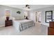 Bright main bedroom featuring two windows, two nightstands and an adjacent bathroom at 890 Coronado Dr, Punta Gorda, FL 33950