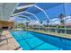 Relaxing screened pool area with clear blue water and waterfront views at 890 Coronado Dr, Punta Gorda, FL 33950