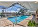 Sparkling screened pool with an outdoor seating area and scenic canal views at 890 Coronado Dr, Punta Gorda, FL 33950