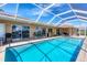 Inviting screened-in pool area with comfortable seating, offering a perfect outdoor retreat with plenty of sunshine at 890 Coronado Dr, Punta Gorda, FL 33950