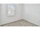 Neutral bedroom with plush carpet, a window with blinds, and a white door at 9535 Coastline Way, Parrish, FL 34219