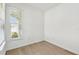 Bright bedroom features wood-look flooring, a window with blinds, and neutral paint at 9535 Coastline Way, Parrish, FL 34219