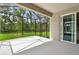 Screened lanai provides tranquil outdoor living with lush green views and a sliding glass door at 9535 Coastline Way, Parrish, FL 34219