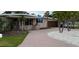 Inviting single-story house featuring a brick-paved driveway and tropical landscaping at 997 Boca Ciega Isle Dr, St Pete Beach, FL 33706