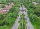 Scenic aerial view of a gated community entrance surrounded by lush landscaping and mature trees at 10130 Deercliff Dr, Tampa, FL 33647