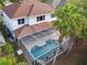 Aerial view shows a screen-enclosed pool and the home's backyard that is lined with palm trees at 10130 Deercliff Dr, Tampa, FL 33647