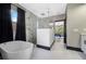 Bathroom featuring free-standing tub, glass shower, and view into the Primary bedroom at 10130 Deercliff Dr, Tampa, FL 33647