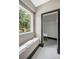 Bright bathroom with a cozy sitting area and window leading to a walk-in closet at 10130 Deercliff Dr, Tampa, FL 33647